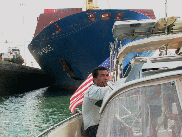 Moira in Gatun Locks, Panama Canal transit; ACP advisor in foreground, Cap Blanche freighter in background